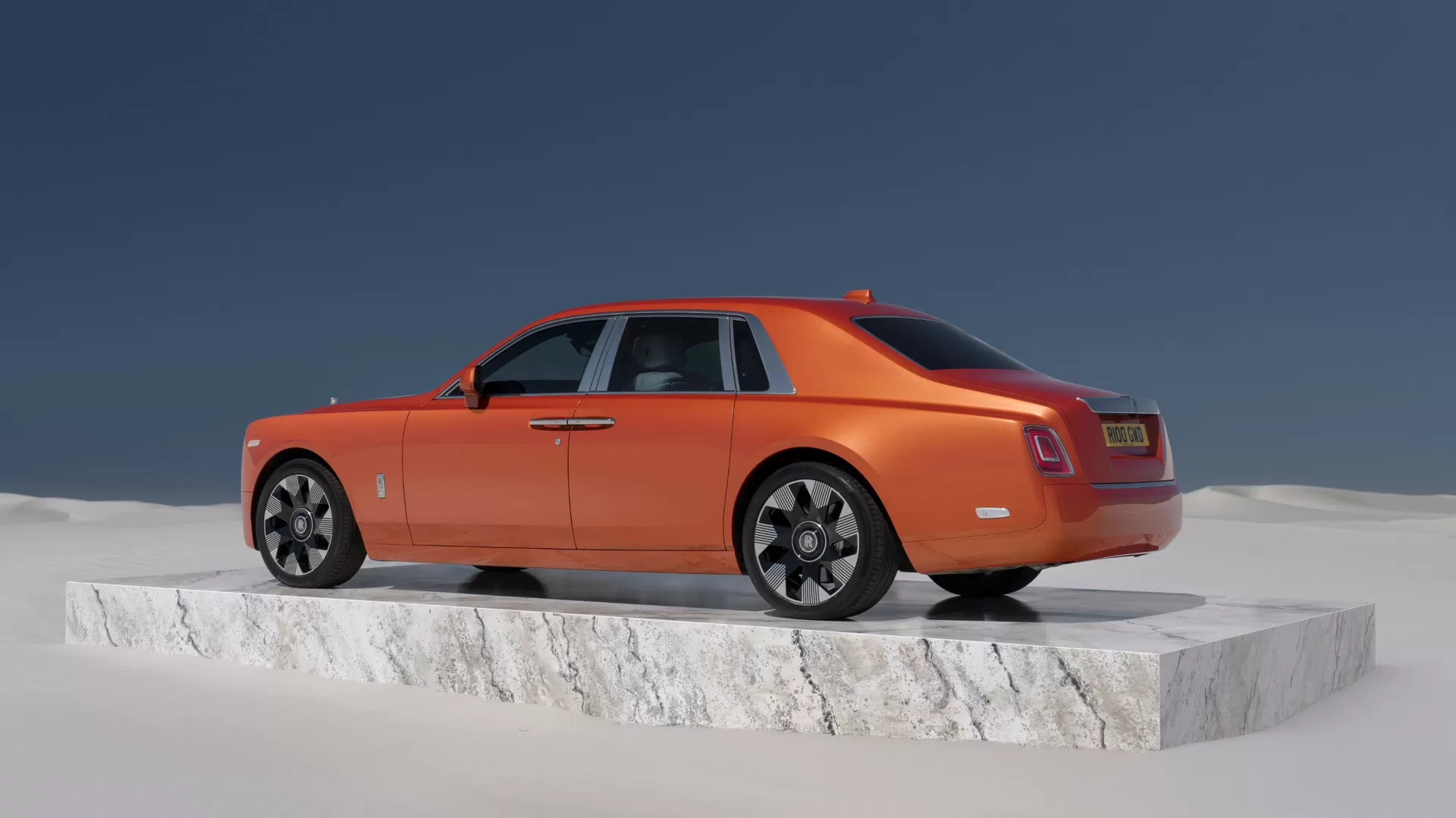 Rear 3/4 of an Orange Phantom on a slab of marble in the middle of the desert 